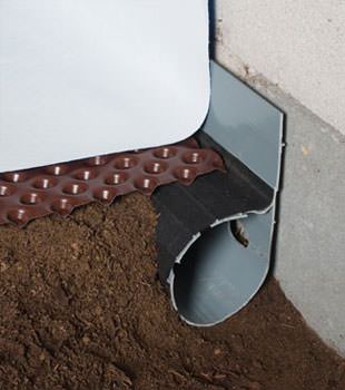 Closeup of a crawl space drainage system installed in Regina