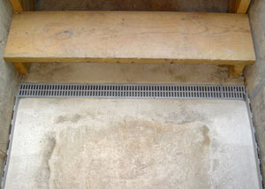 Our grated drain system installed on a leaking basement staircase in Regina.