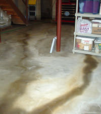 Flooding entering a basement through a floor crack in Boissevain