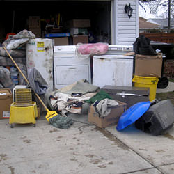 Soaked, wet personal items sitting in a driveway, including a washer and dryer in Melville.