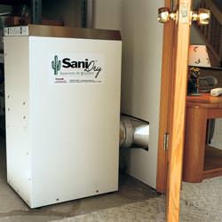 A basement dehumidifier with an ENERGY STAR® rating ducting dry air into a finished area of the basement  in Melita
