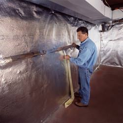 Installation of a radiant heat and vapor barrier on a basement wall in Rivers