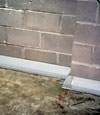 Our baseboard drain system installed on a corner in a White City basement.