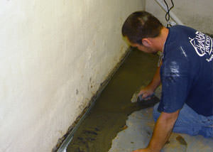 Restoring a concrete slab floor with fresh concrete after jackhammering it and installing a drain system in Langenburg.