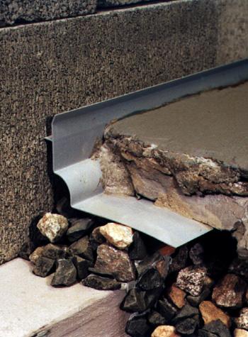 A basement weeping tile system installed on an extremely thin concrete slab floor