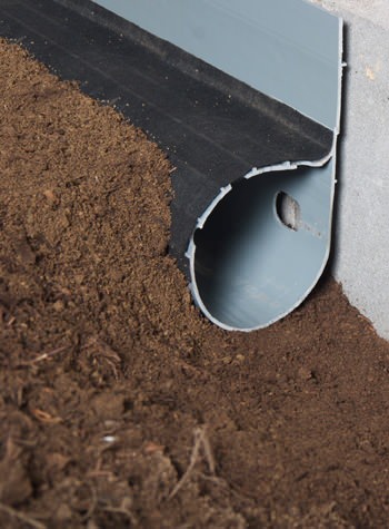 A weeping tile system for dirt crawl space floors with groundwater infiltration