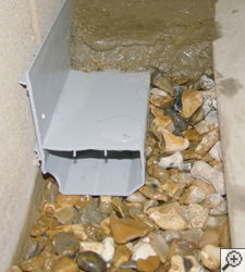 A no-clog basement french drain system installed in Virden
