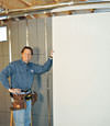 Installing wall panels on top of our basement wall insulation in Melville