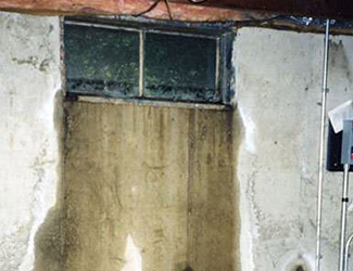 Water pouring out from a basement window in Weyburn